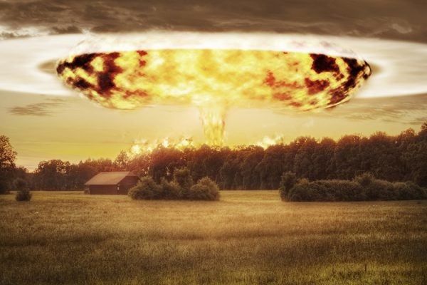 Atomic Bomb and Mushroom Cloud over Rural Landscape