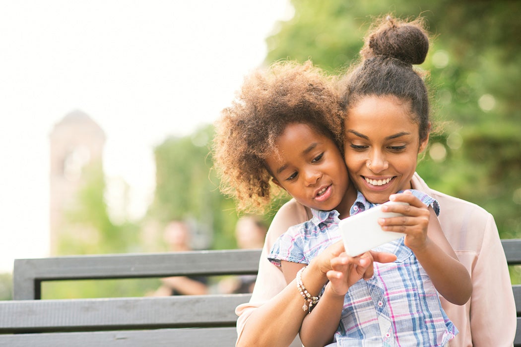 Mother and daughter using smartphone