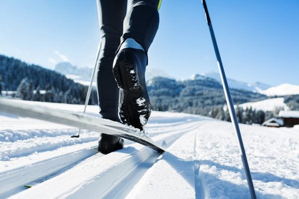 Close-up of a mans legs doing cross-country skiing in the Alps.