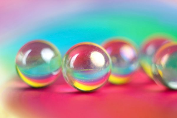 Marbles Reflecting a Rainbow Background