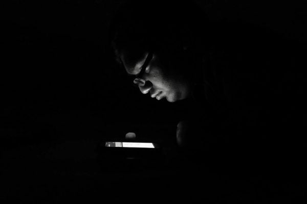 Man Using Phone In Darkroom