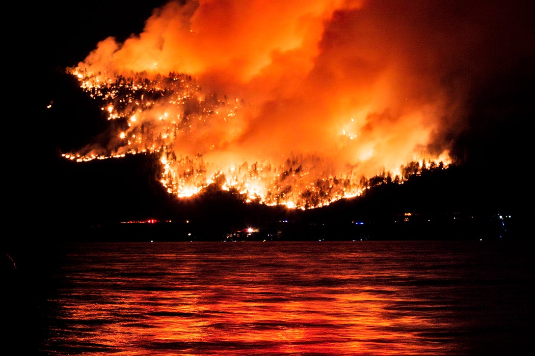 A forest fire reflected in Okanagan Lake, British Columbia, Canada