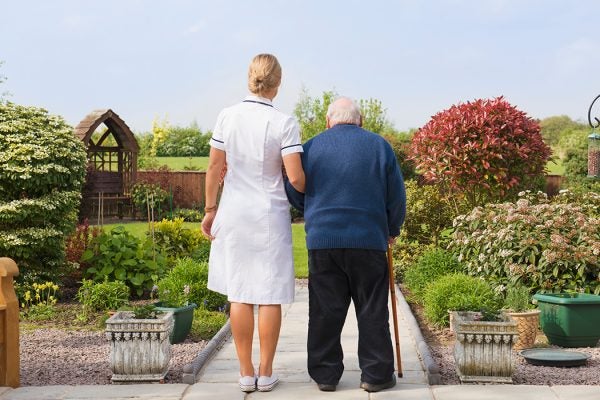 A nurse helping an elderly patient