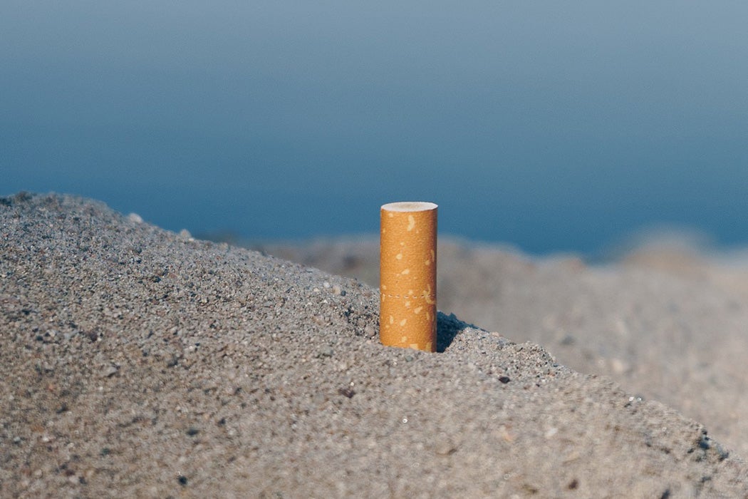 A cigarette butt in the sand.