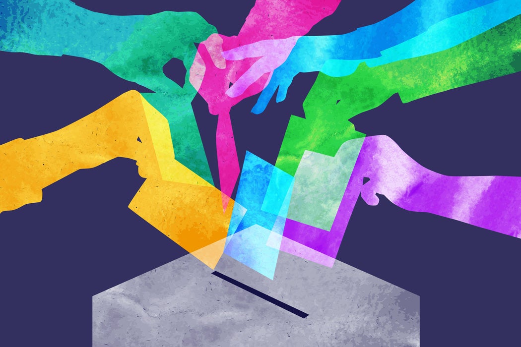 An illustration of hands around a ballot box