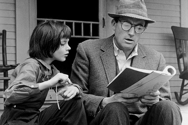 Gregory Peck and Mary Badham review the script for the film, 'To Kill a Mockingbird' directed by Robert Mulligan.