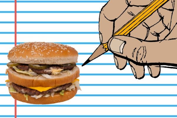 A person's hand drawing a Big Mac hamburger on a sheet of lined paper