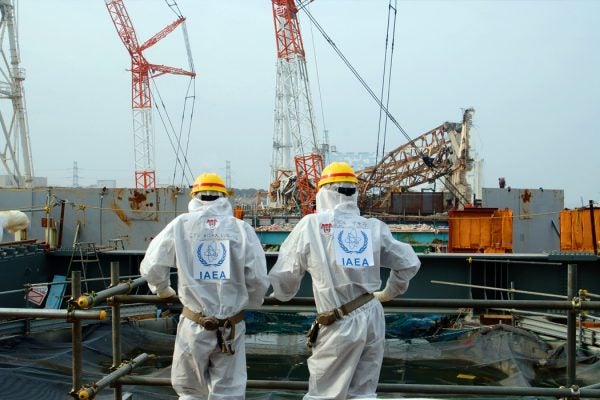 Two IAEA experts examine recovery work on top of Unit 4 of TEPCO's Fukushima Daiichi Nuclear Power Station