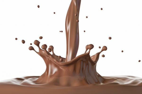 Liquid chocolate crown splash with ripples. Side view. On white background. Clipping path included.