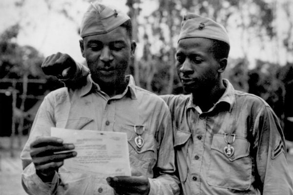 The first black marines decorated by the famed 2nd Marine Dvision somewhere in the Pacific. (Left to right) Staff Sgt Timerlate Kirven and Cpl. Samuel J. Love, Sr., received Purple Hearts for wounds received in the Battle of Saipan.