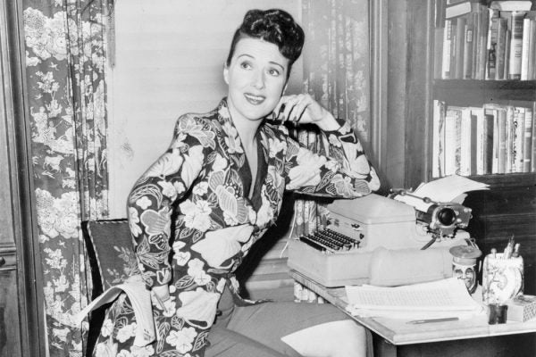 Gypsy Rose Lee seated at a typewriter