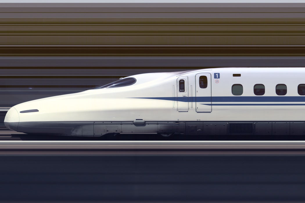 The Shinkansen N700A Series Set G13 high speed train travelling at approximately 300 km/h through Himeji Station, Japan