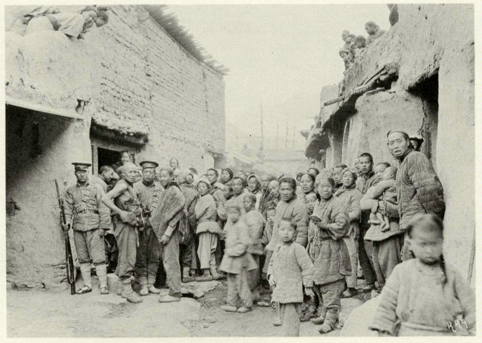 The people of Chingshui, Kansu, are gathered in front of the inn where Joseph Rock stayed, listening to his phonograph