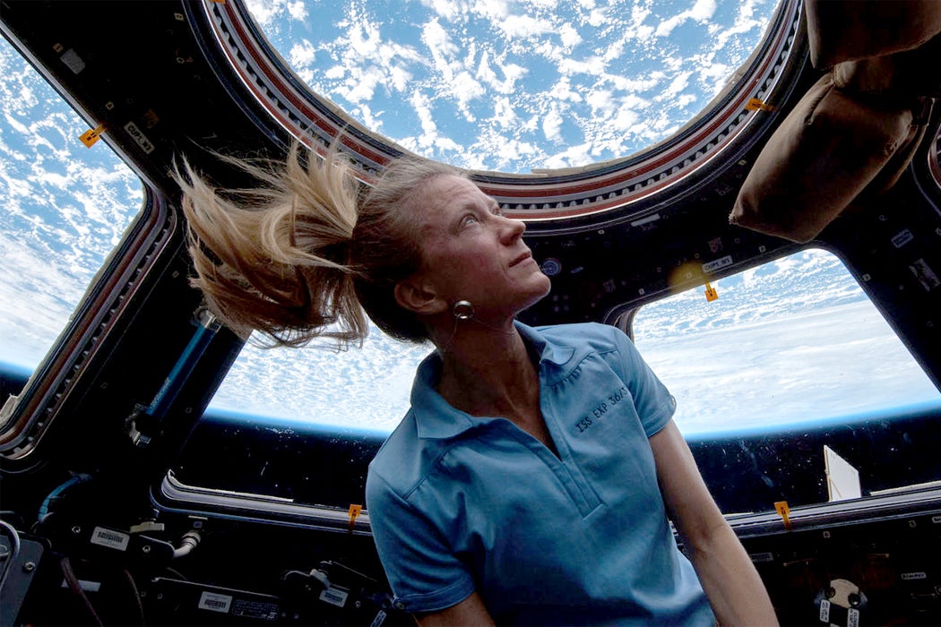 Astronaut Karen Nyberg looks at Earth through a cupola on the ISS.