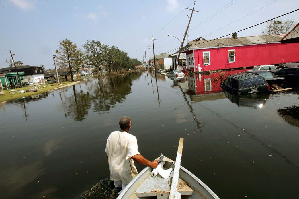 Ira Jackson pulls his boat through a flooded street September 5, 2005 in New Orleans, Louisiana after Hurricane Katrina
