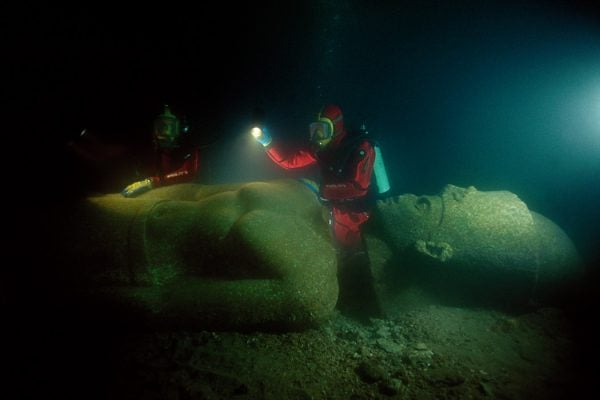archaeologists Franck Goddio and his team inspect the colossal red granite statue of a pharaoh of over 5 metres height, weighing 5.5 tons, and shattered into 5 fragments. It was found close to the great temple of sunken Heracleion.