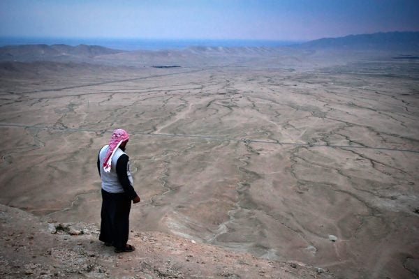 A man looking at land affected by drought