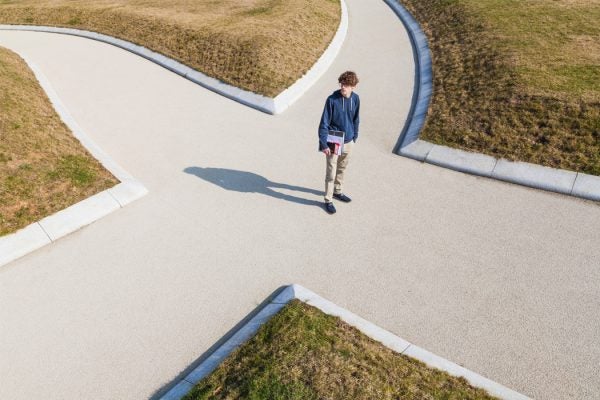 A student standing at a crossroads