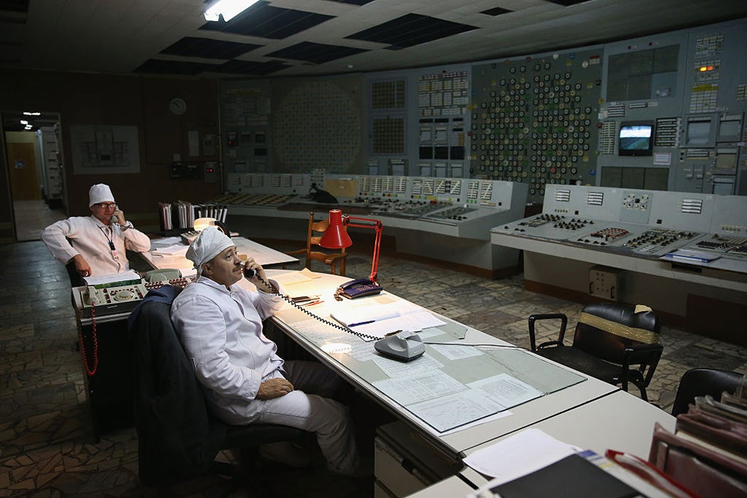 Workers sit in the control room of reactor number two inside the former Chernobyl nuclear power plant