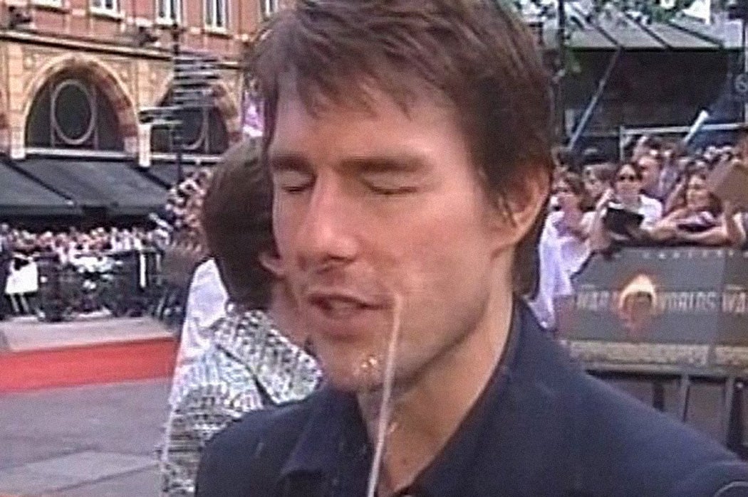 Tom Cruise is sprayed with water during an interview
