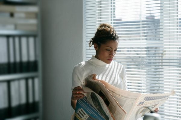 A woman reading a newspaper
