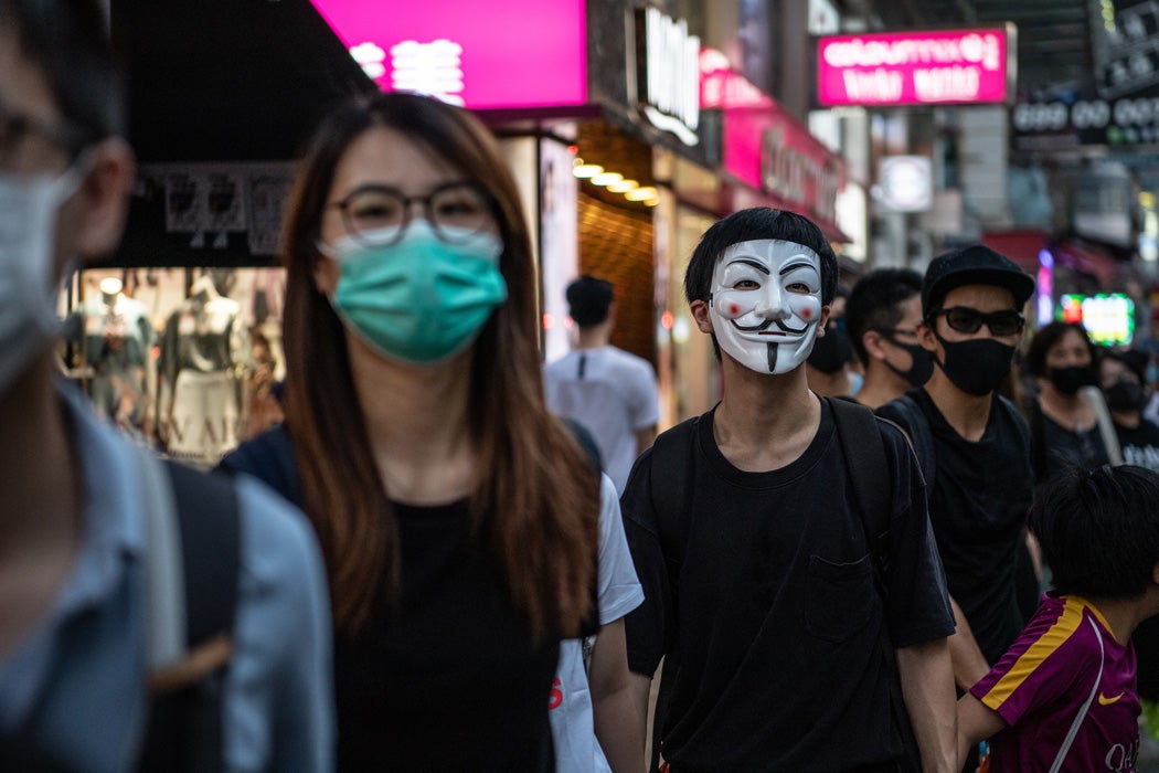 People protest a ban against masks
