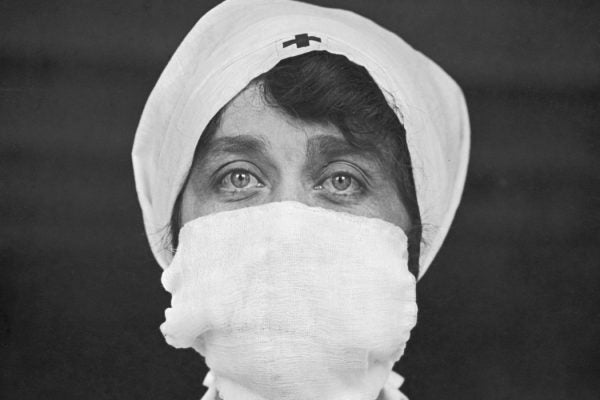 A Red Cross nurse wearing a face mask, c. 1918