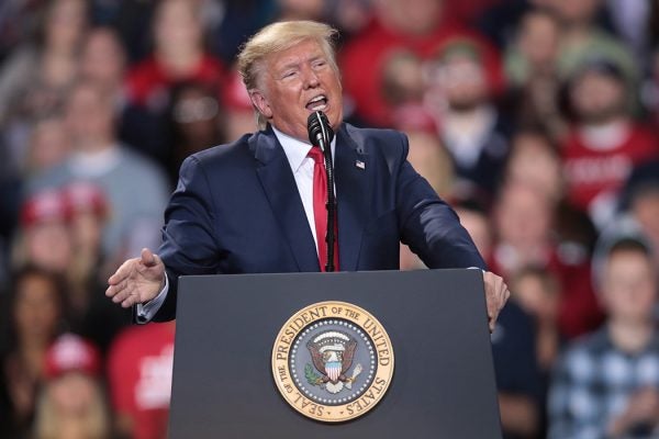 Photograph: Donald Trump addresses his impeachment after learning how the vote in the House was divided during a Merry Christmas Rally at the Kellogg Arena on December 18, 2019 in Battle Creek, Michigan. 

Source: Getty