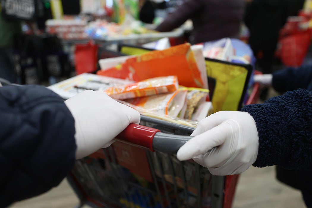 People wearing latex gloves while food shopping in Merrick, NY, March 17, 2020
