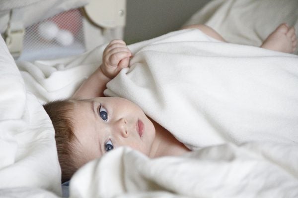 A baby lying in some blankets