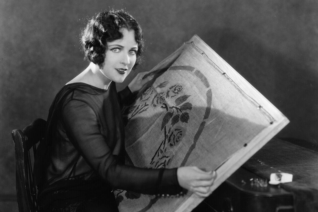 Hollywood film star and actress Jacqueline Logan preparing a rug pattern for embroidery, c. 1928