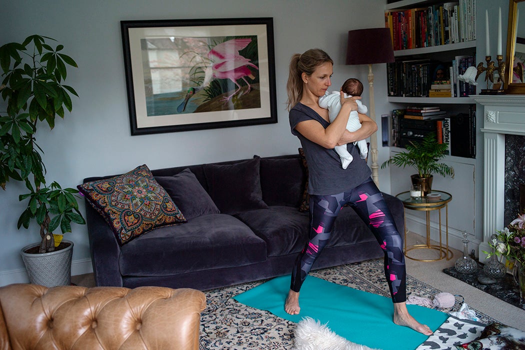 A mother and her baby doing yoga in their apartment