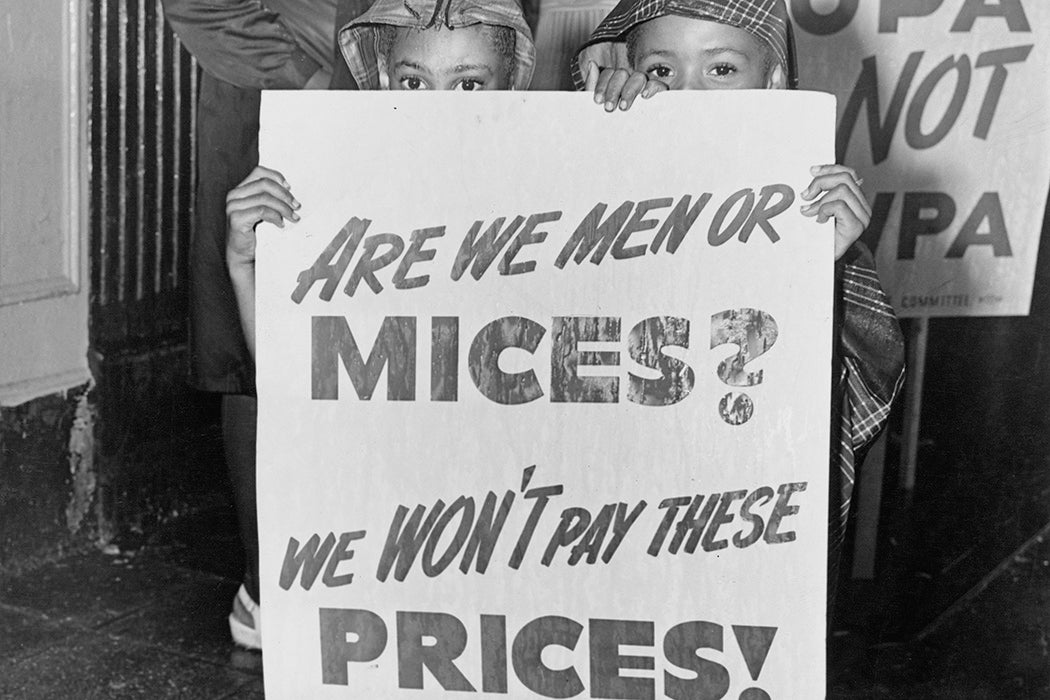 Two young children holding placard which reads "Are we men or mices? We won't pay these prices" at a demonstration in Harlem between the 116th and the 125th to protest against housing conditions and rent price, New York City, US, July 1946.