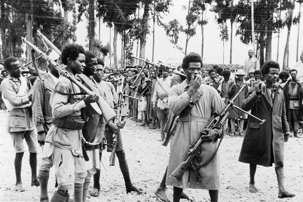 Ethiopian men gather in Addis Ababa, heavily armed with captured Italian weapons, to hear the proclamation announcing the return to the capital of the Emperor Haile Selassie in May 1941