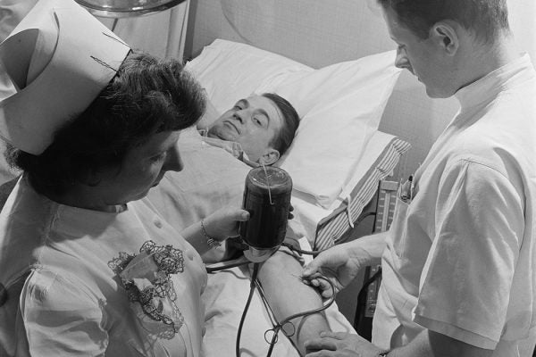 Medical staff taking blood from a blood donor at the Princeton Medical Center in New Jersey, USA, circa 1950.