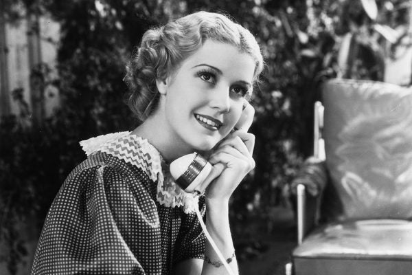 Anita Louise chats on the telephone in a scene from The Gay Lady, 1935