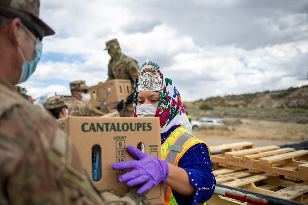 Miss Navajo Nation Shaandiin P. Parrish grabs a box filled with food and other supplies to distribute to Navajo families on May 27, 2020 in Counselor on the Navajo Nation Reservation, New Mexico.