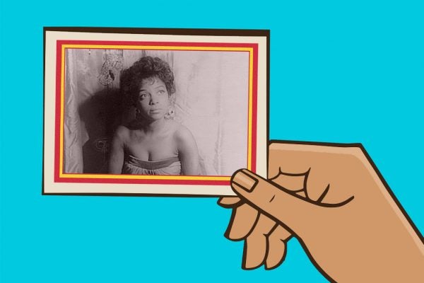 A hand holding a trading card featuring Ruby Dee