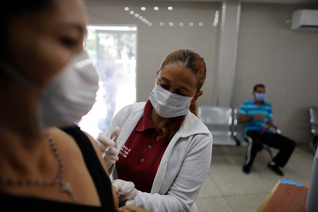 A nurse applies a vaccine in Caracas, Venezuela in March, 2020
