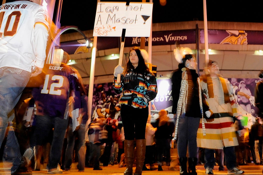Raven Ziegler from Minneapolis protests the name of the Washington Redskins before a game on November 7, 2013