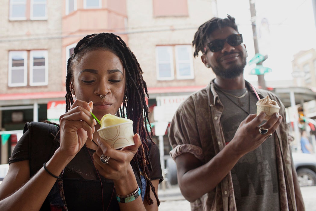 A young man and woman eating ice cream.