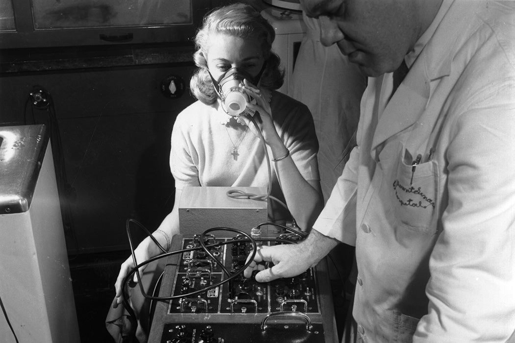 Photograph: A woman helps in the research into hay fever by breathing into a machine that records breathing patterns. 

Source: Getty