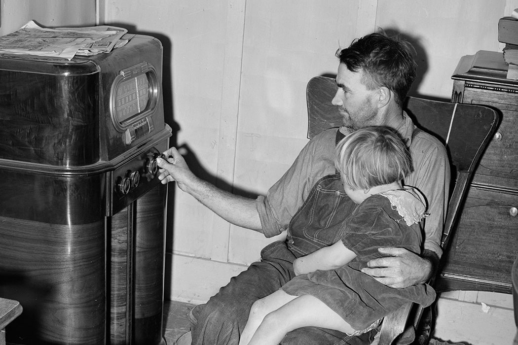 John Frost and daughter listening to radio in their home. Tehama County, California