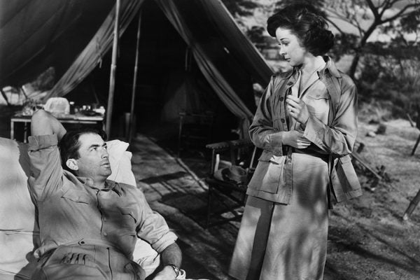 Gregory Peck looking up at Susan Hayward in a scene from the film 'The Snows Of Kilimanjaro', 1952.