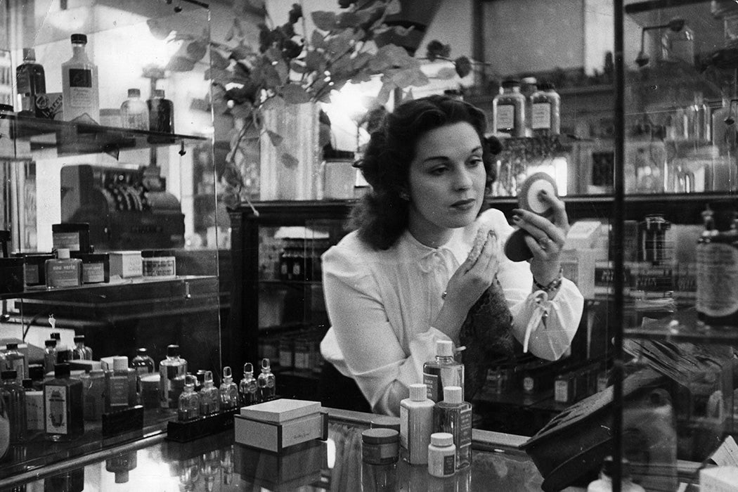 A sales assistant at the perfume counter of a department store, 1946