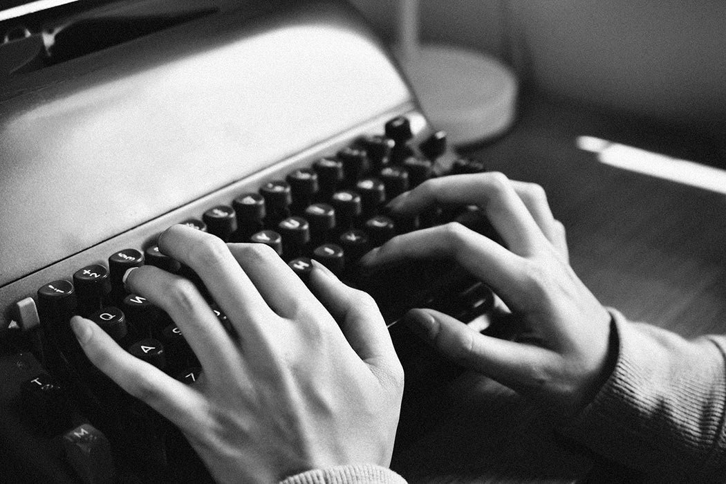 A woman typing on a typewriter