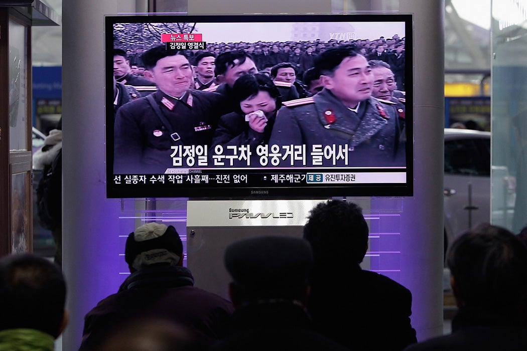 People watch a television broadcast reporting the late North Korean leader Kim Jong-Il's funeral at the Seoul Railwat Station on December 28, 2011 in Seoul, South Korea.