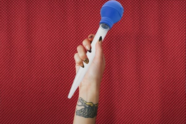 A woman's hand holding a turkey baster