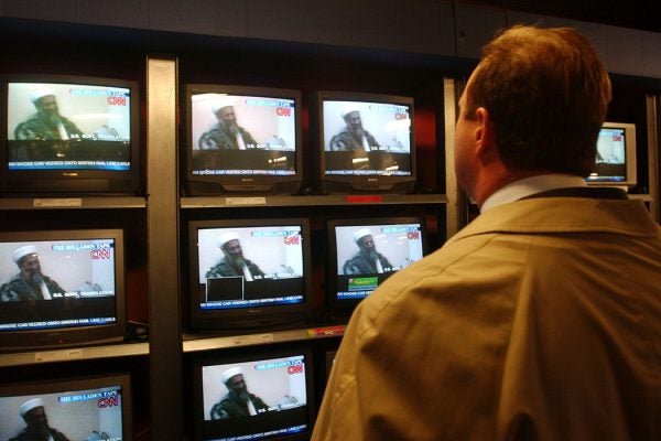 A man watches the CNN broadcast of the Osama bin Laden tape December 13, 2001 in a New York City store after it was released by the Pentagon.