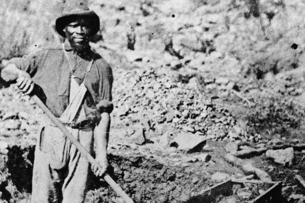 An African-American miner poses with a shovel in Auburn Ravine during the Gold Rush, California, 1852.